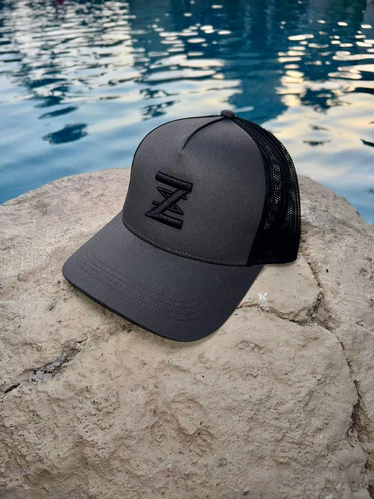 Grey and black logo cap trucker cap.